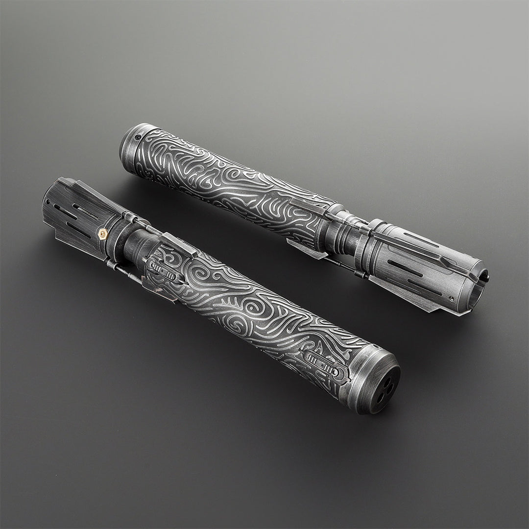 Two metallic saber with intricate patterns on a gray background